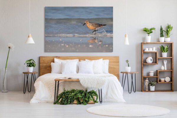 A bedroom with a large canvas print of "A Day at the Beach".