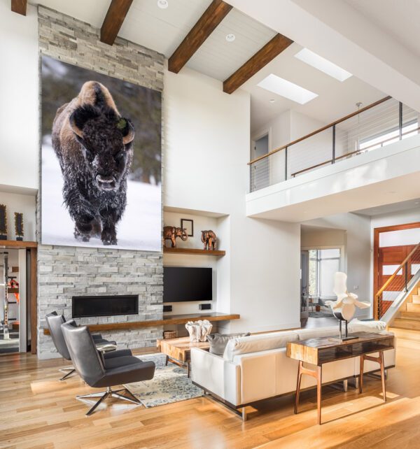 A living room with a large Frosty Bison hanging on the wall.