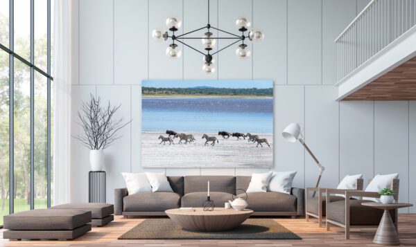 A living room with a large painting of Running Free.