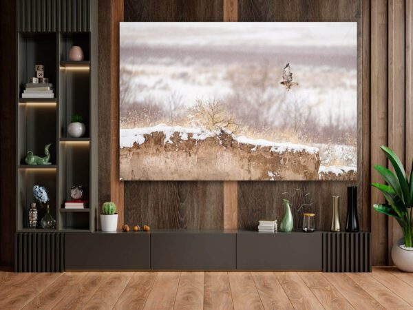 A living room with a large painting of Winter Flight in the snow.